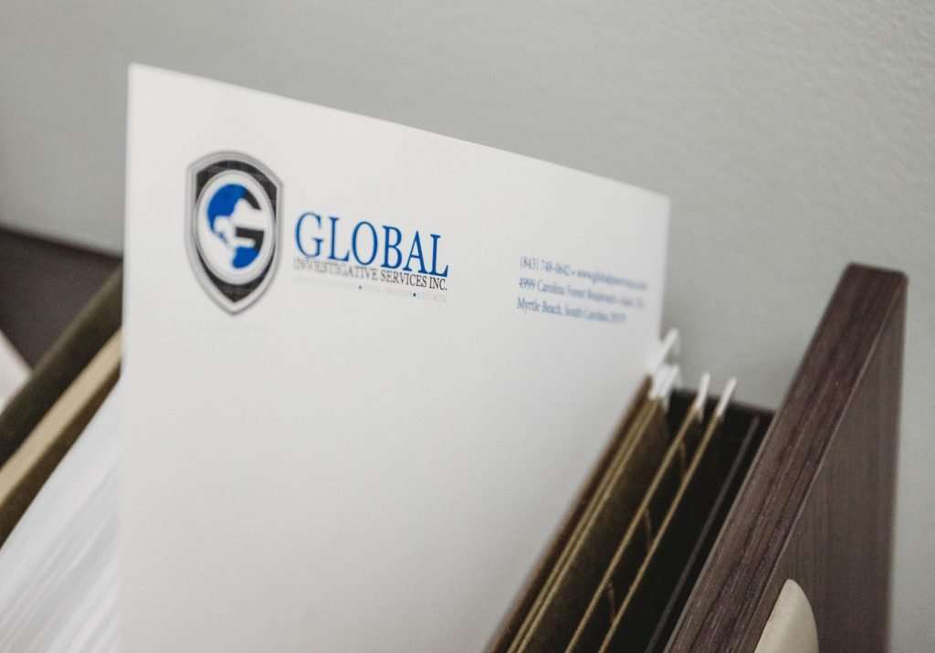 Private Background Checks | Image of Paper Files with GIS Logo Printed