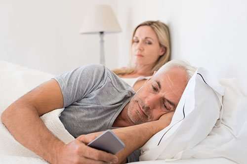 Adultery Investigations | Image of a married couple lying in bed