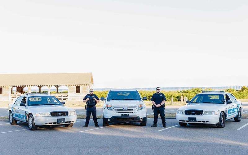 Executive Protection |Image of Two Officers with Patrol Cars